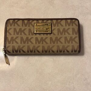 Gently used but in good condition Michael Kors Tan and Brown Logo Zip Wallet